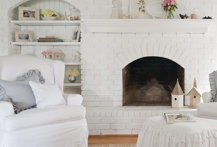 chic living room with white brick fireplace and wall