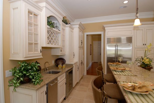traditional kitchen with antique cabinets with white molding trim