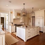 traditional kitchen with antique white cabinets and medium tone hardwood flooring