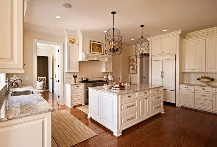 traditional kitchen with antique white cabinets and medium tone hardwood flooring
