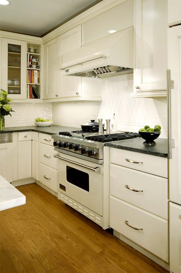 traditional kitchen with antique white cabinets and white appliances