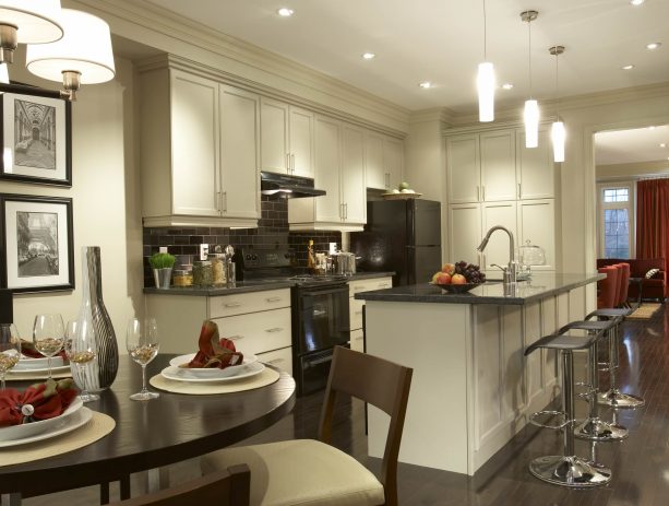 traditional open kitchen with antique white recessed style cabinets and black appliances