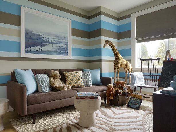 contemporary living and playroom with large blue-themed wall painting and coffee brown couch color ideas