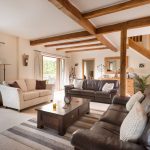 open style country living room with white wall and brown furniture