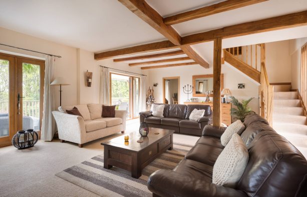 open style country living room with white wall and brown furniture