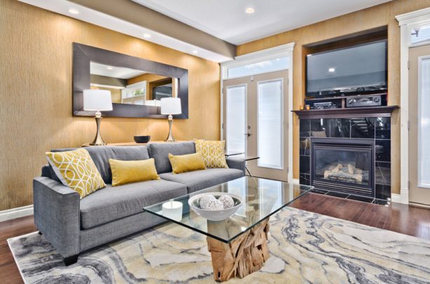 contemporary grey and yellow living room with yellow dandelion wall