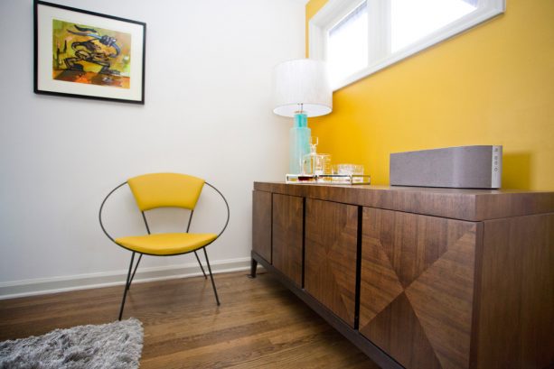 contemporary living room with butter yellow accent wall