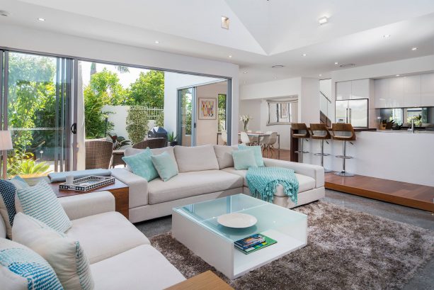 grey and blue beach-style living room with green view