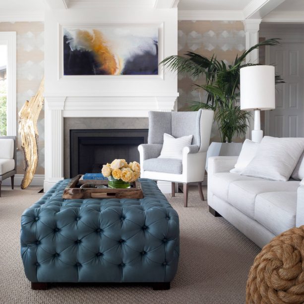 grey and blue transitional living room with ocean blue rectangle tufted ottoman