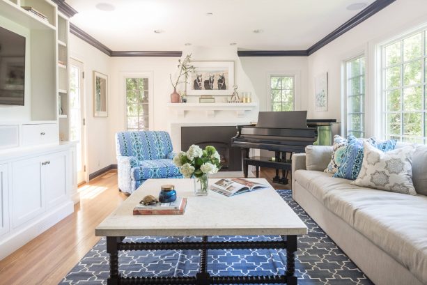 grey and blue transitional living room with patterned rug and amrchair