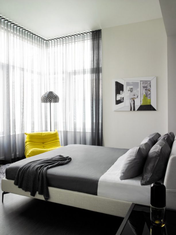 grey and white bedroom with accentuating lemon yellow chair