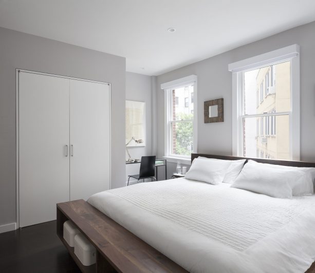 grey and white bedroom with coffee brown wooden bed