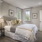 grey and white bedroom with corn yellow accents