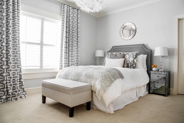 grey and white bedroom with dark mirrored side tables