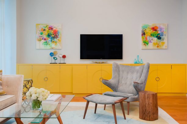 grey and yellow living room with custom canary yellow cabinets