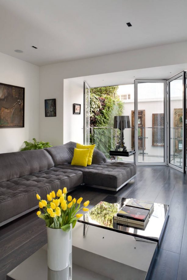 grey and yellow living room with fresh yellow tulips in light grey vase