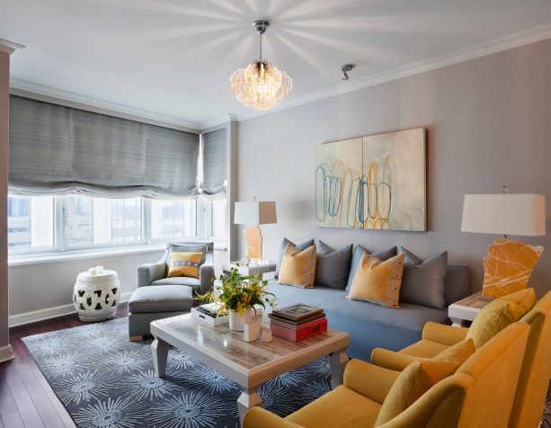 grey and yellow living room with mustard chairs and pillows