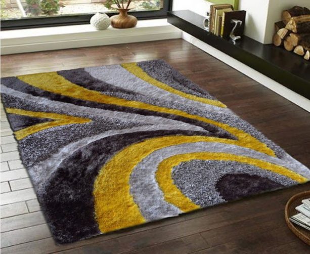 modern grey and yellow area rug with swirl-like pattern
