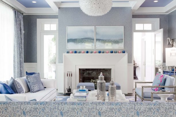 transitional grey and blue living room with cloudy mountain-themed wall artwork