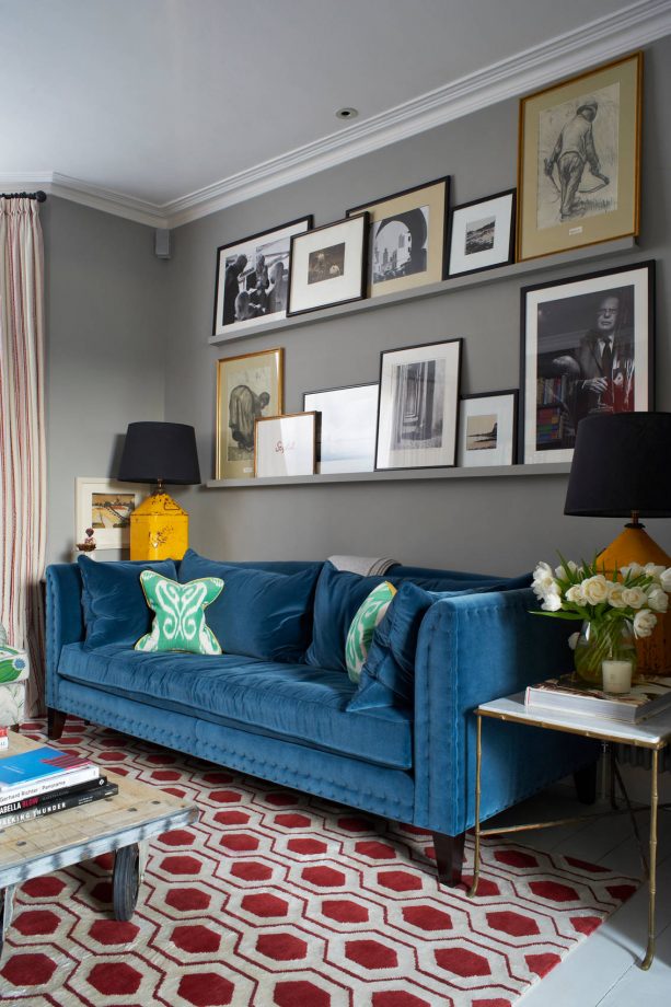 transitional grey and blue living room with sangria red rug