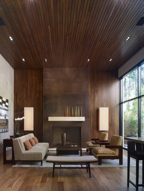 grey and brown living room with floor to ceiling fireplace