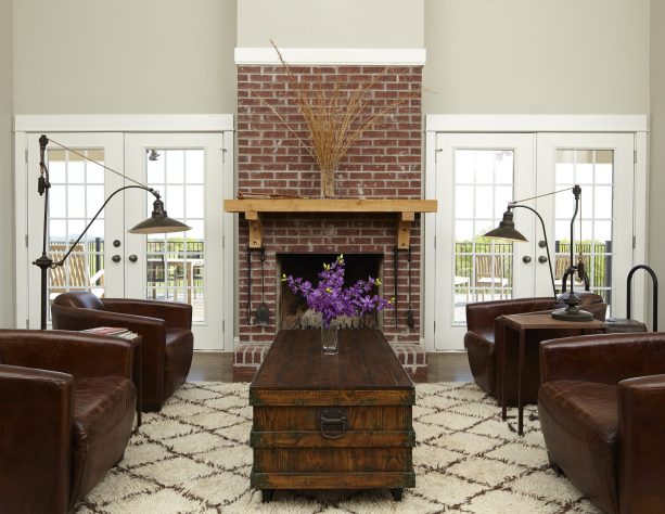 grey and brown living room with four leather chairs