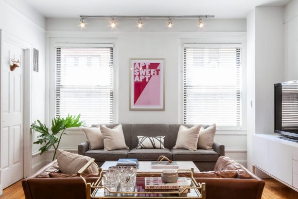 grey and brown living room with golden bar cart