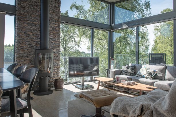 grey and brown living room with large glass windows