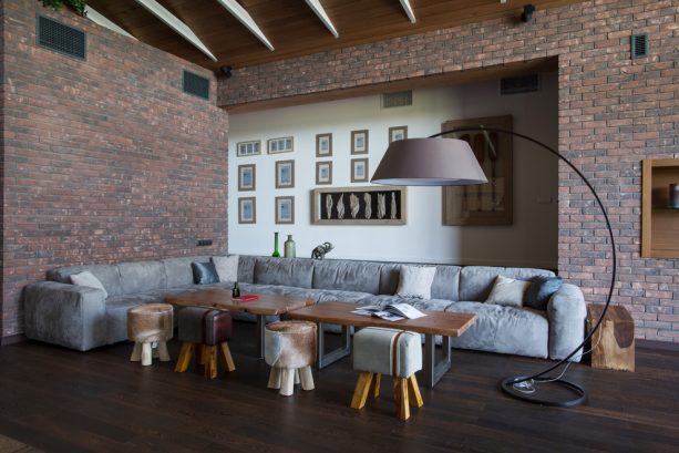 grey and brown living room with sectional and ottomans