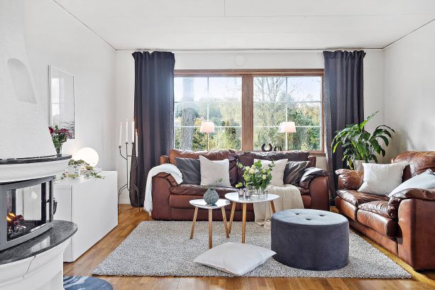 grey and brown living room with two bulky leather sofas