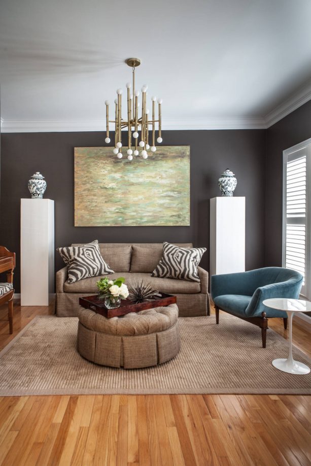 grey and brown living room with zebra print pillows