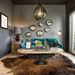 grey and teal living room with brown bear skin rug