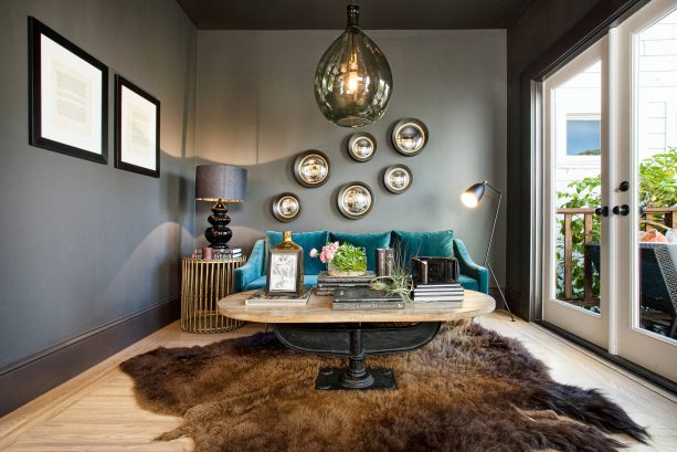 grey and teal living room with brown bear skin rug