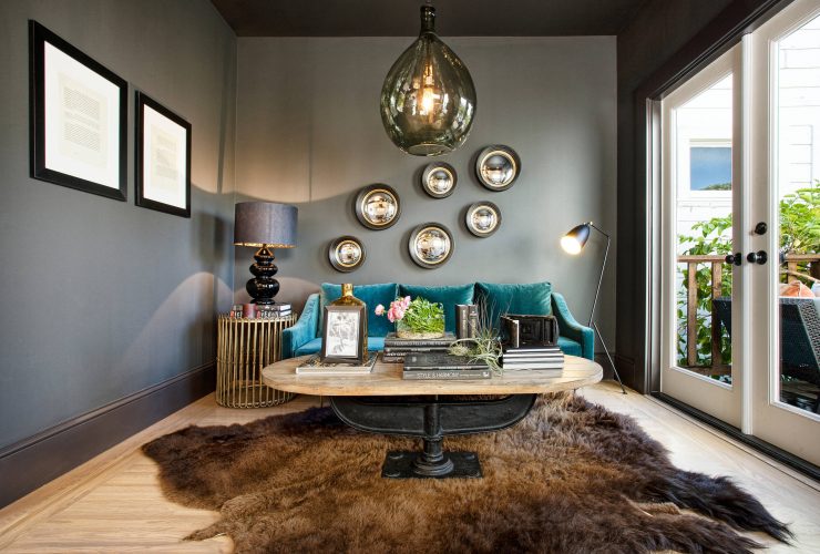 grey and teal living room with brown bear skin rug