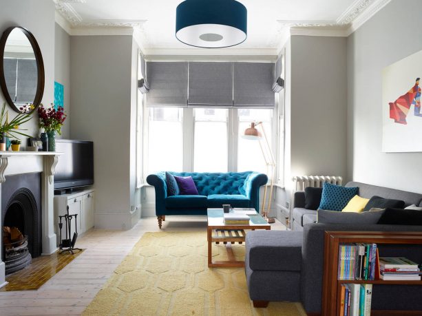 grey living room with teal tufted sofa