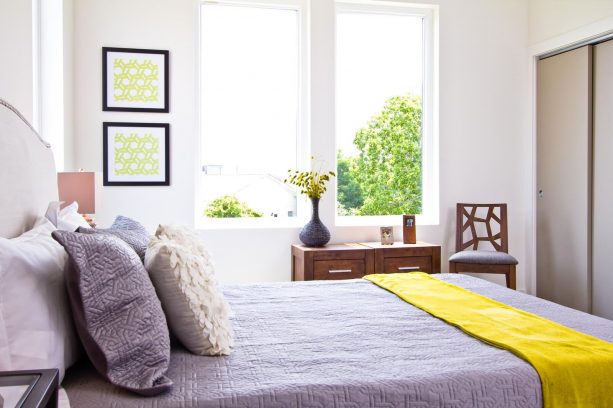 airy grey and yellow bedroom