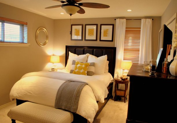 an inviting bedroom with grey, yellow, and black color scheme