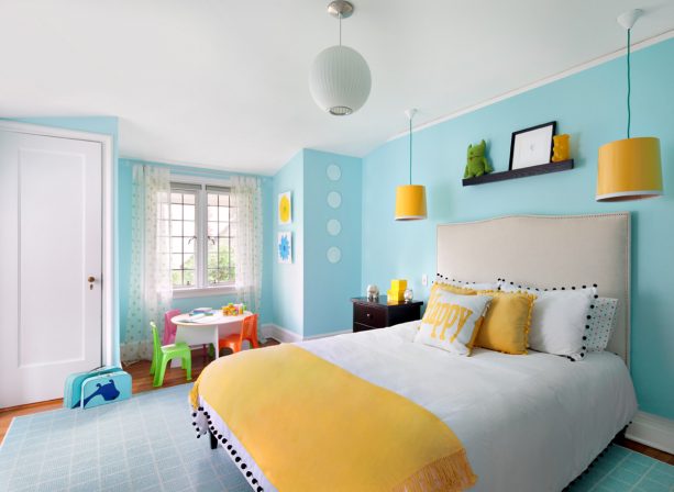 grey and yellow bedroom with a bright blue wall