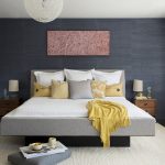 grey and yellow bedroom with charcoal grey accent wall