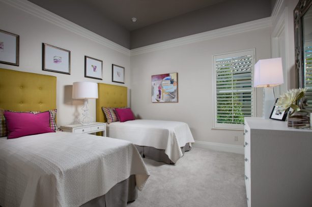 grey and yellow bedroom with pink pillows