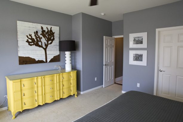 grey bedroom with custom yellow dresser