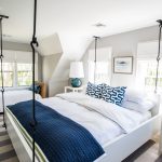 light grey bedroom with navy pillows and blanket