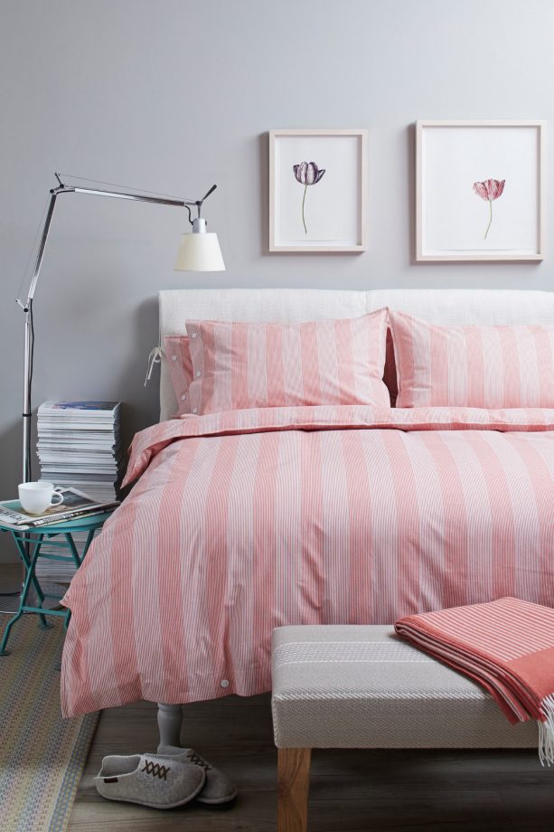 pink and grey bedroom with a purplish wall