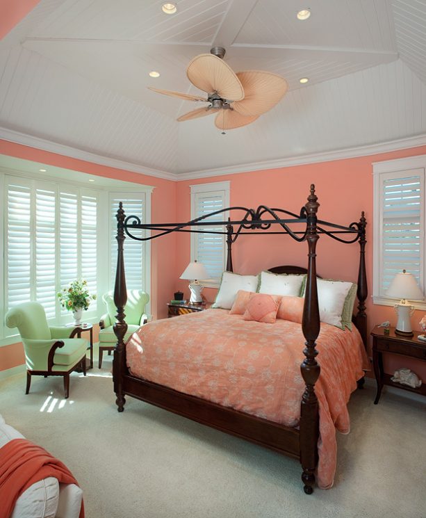 pink and grey bedroom with elegant wooden bed and canopy frame