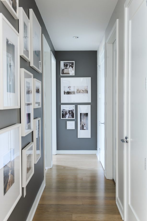 a hallway with dark grey paint and white trim