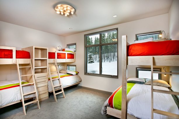 bedroom with light gray walls and red-white-lime green bedding set