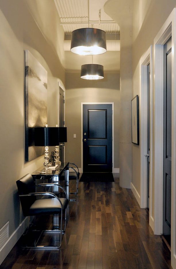 beige hallway with black doors and white trim
