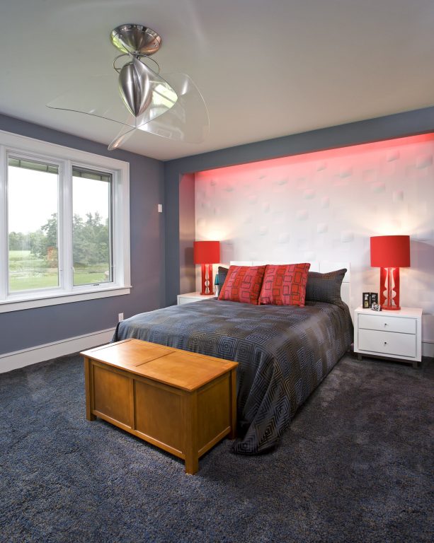 contemporary bedroom with charcoal grey and white walls, red accents, and glass windows