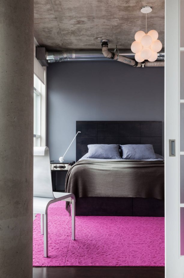 contemporary grey bedroom with pink area rug