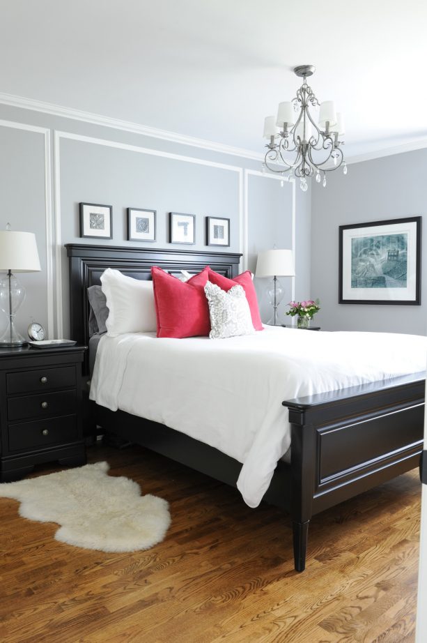 grey and red bedroom with black bed and black nightstands